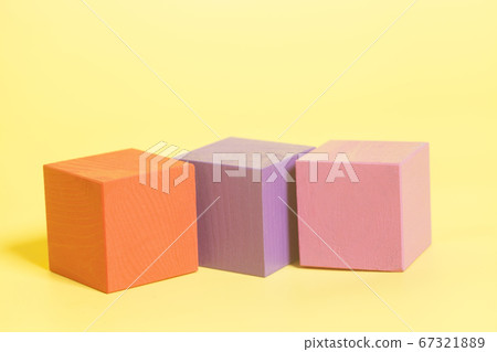 Multiple colored cubes on yellow background 67321889