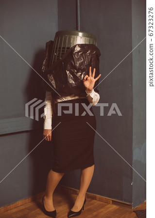 Ok gesture from businesswoman standing in trash can. Crisis concept. Lock down concept. Unemployment concept. Tinted image Ok gesture from businesswoman standing in trash can. Crisis concept. Lock down concept. Unemployment concept. Tinted image 67323276
