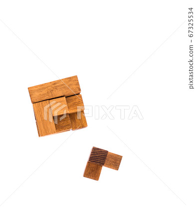 Wooden puzzle cube 7. Wooden puzzle consisting of 7 parts isolated on a white background. 67325534