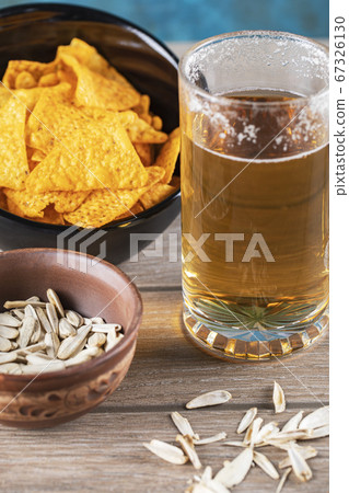 Beer mug with sunflower seeds and chips Beer mug with sunflower seeds and chips 67326130