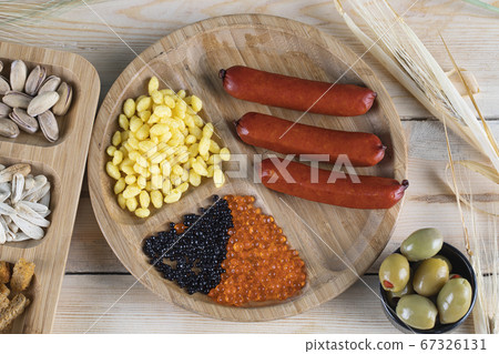 Sausages, marinated corn seeds and olives Sausages, marinated corn seeds and olives 67326131