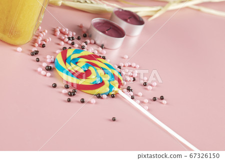 Rainbow popsicle with pink pearl candies around 67326150