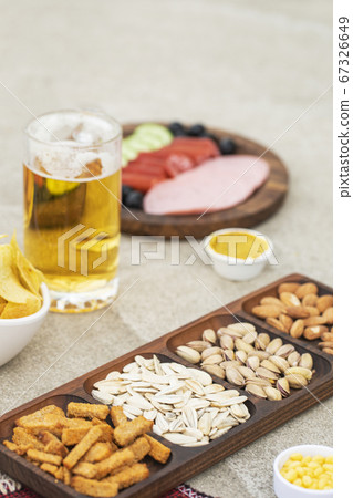 Dry fruits and crackers with a beer mug 67326649