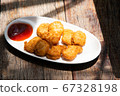 chicken nugget fry on white round ceramic plate with pepper half ketchup source on wood table stock photo 67328198