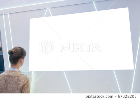 Woman looking at blank white display wall at exhibition - mockup image Woman looking at blank white display wall at exhibition - mockup image 67328205