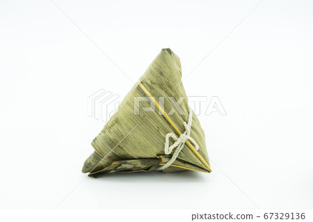 Closeup view of the zongzi (sticky rice dumplings), it is a traditional Chinese rice dish made of glutinous rice stuffed with different fillings and wrapped in reed leaves. Closeup view of the zongzi (sticky rice dumplings), it is a traditional Chinese rice dish made of glutinous rice stuffed with different fillings and wrapped in reed leaves. 67329136