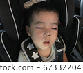 Tired little boy sleeping with his child seat open mouth 67332204