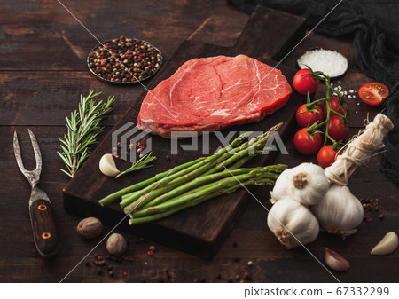 Slice of raw fresh beef braising steak on board 67332299