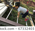 Little boy playing athletic with a cap on 67332403