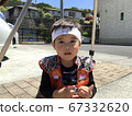 A boy looking at the camera in Momotaro's cosplay 67332620