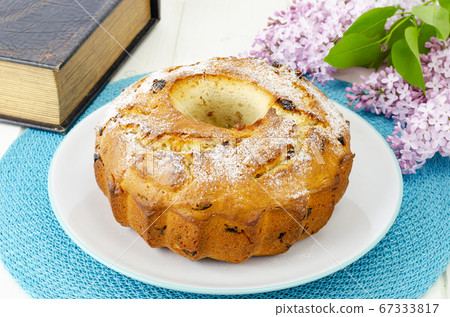 Delicious homemade raisin cupcake, lilac flowering 67333817