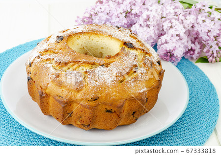 Delicious homemade raisin cupcake, lilac flowering 67333818