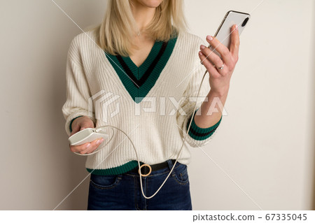 Thoughtful girl plays in the phone and infects it Thoughtful girl plays in the phone and infects it 67335045
