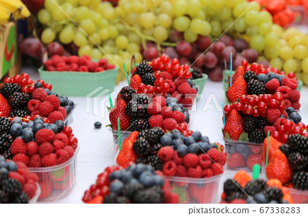 Bright fresh berries and fruits on the market Bright fresh berries and fruits on the market 67338283