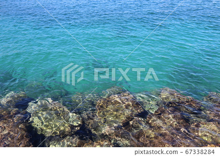 Bright turquoise sea water and stones near the shore Bright turquoise sea water and stones near the shore 67338284