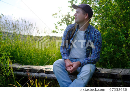 man stopping for rest on countryside walk sitting alone man stopping for rest on countryside walk sitting alone 67338686