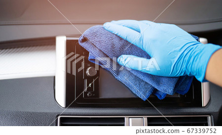 The staff is cleaning the car to prevent the corona virus. The staff is cleaning the car to prevent the corona virus. 67339752