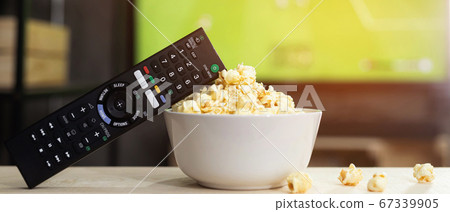 Popcorn with TV remote For watching movies online 67339905