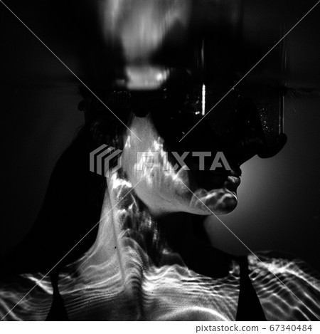 closeup view of beautiful woman in pool water wearing swimming mask closeup view of beautiful woman in pool water wearing swimming mask 67340484