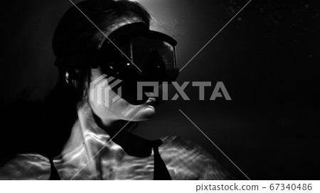 closeup view of beautiful woman in pool water wearing swimming mask closeup view of beautiful woman in pool water wearing swimming mask 67340486