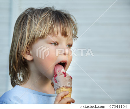 happy little boy eating an ice cream 67341104