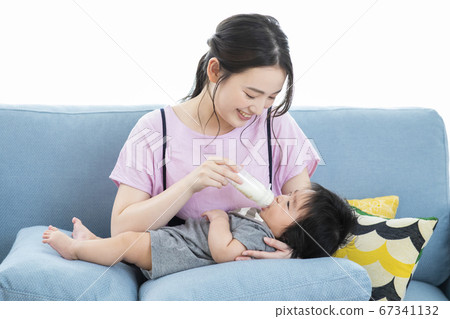 Mom bringing milk to baby Mom bringing milk to baby 67341132