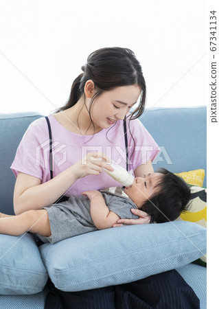 Mom bringing milk to baby Mom bringing milk to baby 67341134