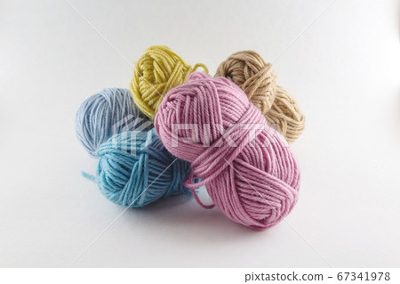 Multi-colored skeins of woolen threads. Close up. 67341978