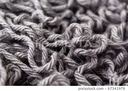 Gray woolen threads for knitting close up. 67341979