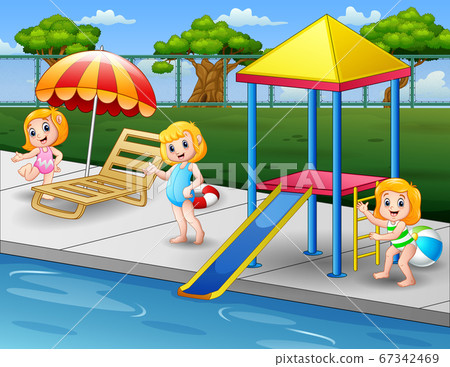 Happy girls playing on pool edge in backyard 67342469