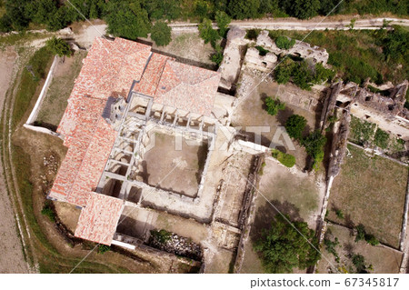 Aerial view of the Ruins Of An Ancient Abandoned Monastery In Santa Maria De Rioseco, Burgos, Spain. 67345817