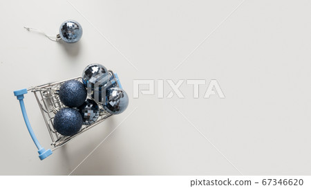 Grocery trolley full of New Years blue balls. Grocery trolley full of New Years blue balls. 67346620