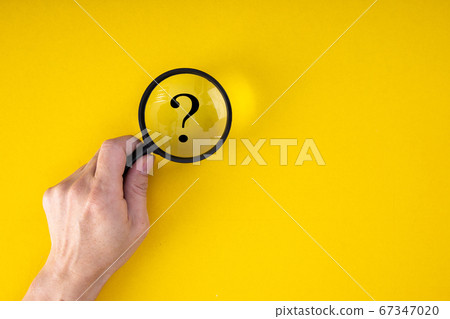 Magnifying glass with QUESTION MARK in focus on 67347020