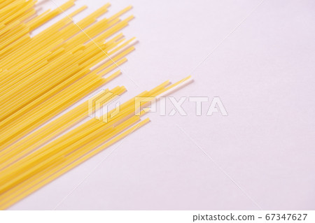 Long pasta on pink background 67347627