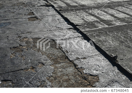 Bitumen flat roofing renovation, background texture of removed damaged insulation layer of roof 67348045