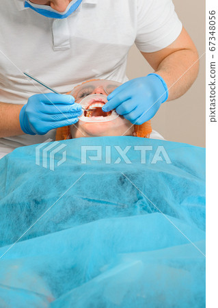 The patient visits the dentist regarding the 67348056