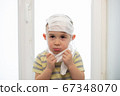 Sad boy wearing many medicine masks, quarantine at home, virus protection 67348070
