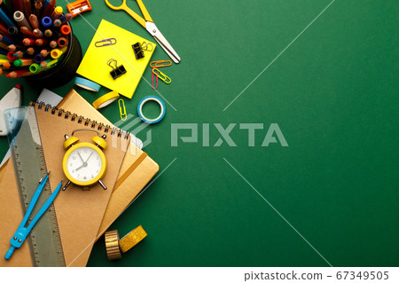 Colorful stationary school supplies on green 67349505
