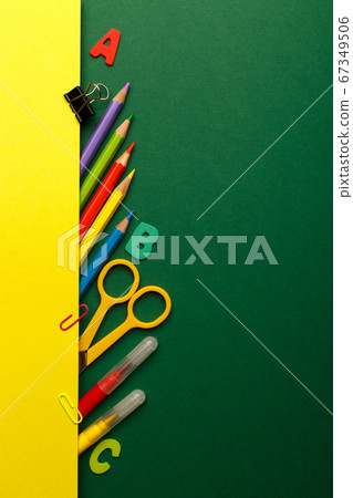 Colorful stationary school supplies on green 67349506