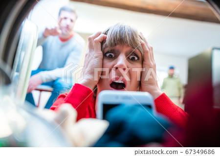 Woman finds her phone in washing drum Woman finds her phone in washing drum 67349686
