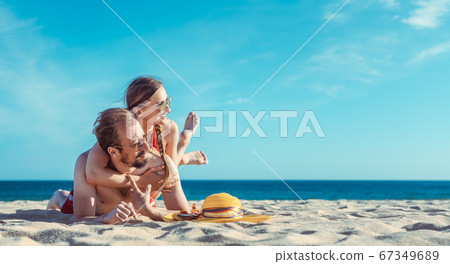Middle aged couple in their summer vacation on the beach Middle aged couple in their summer vacation on the beach 67349689