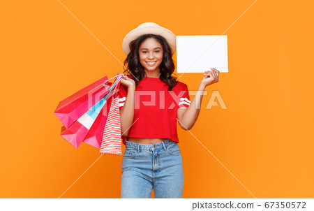 Happy female shopper with blank banner Happy female shopper with blank banner 67350572
