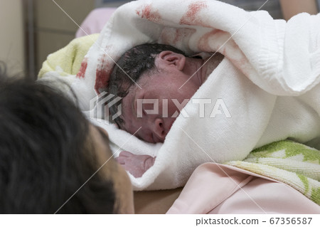 Newborn and mother immediately after childbirth Newborn and mother immediately after childbirth 67356587