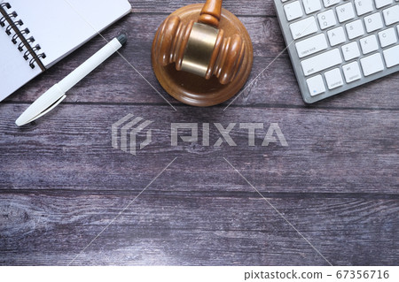 Close up of gavel, keyboard and diary on table  67356716