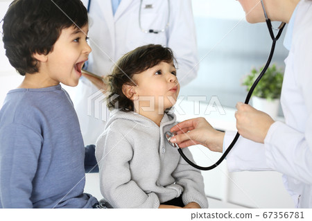 Doctor examining a child patient by stethoscope. Cute arab boy at physician appointment. Medicine and healthcare concept Doctor examining a child patient by stethoscope. Cute arab boy at physician appointment. Medicine and healthcare concept 67356781