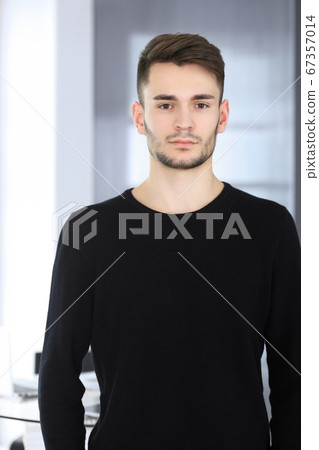 Beard man headshot at modern office. Businessman or student guy standing straight and smiling. Lifestyle concept 67357014