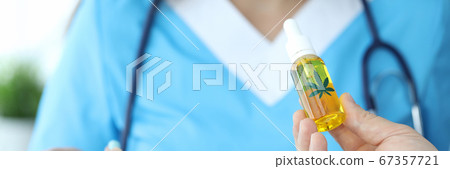 Doctor holding bottle with cannabinoid oil Doctor holding bottle with cannabinoid oil 67357721