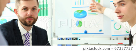 Bunch of businessmen sitting in office solving current problems Bunch of businessmen sitting in office solving current problems 67357737