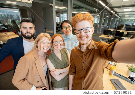 Group of successful office workers with toothy smiles making selfie in office 67359051