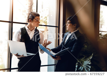 Two Businessman Working Together on Computer 67359227